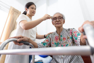caregiver wipes the sweat of the elderly