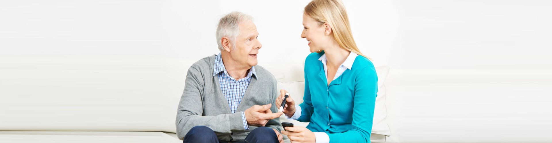 caregiver talking to the elderly man