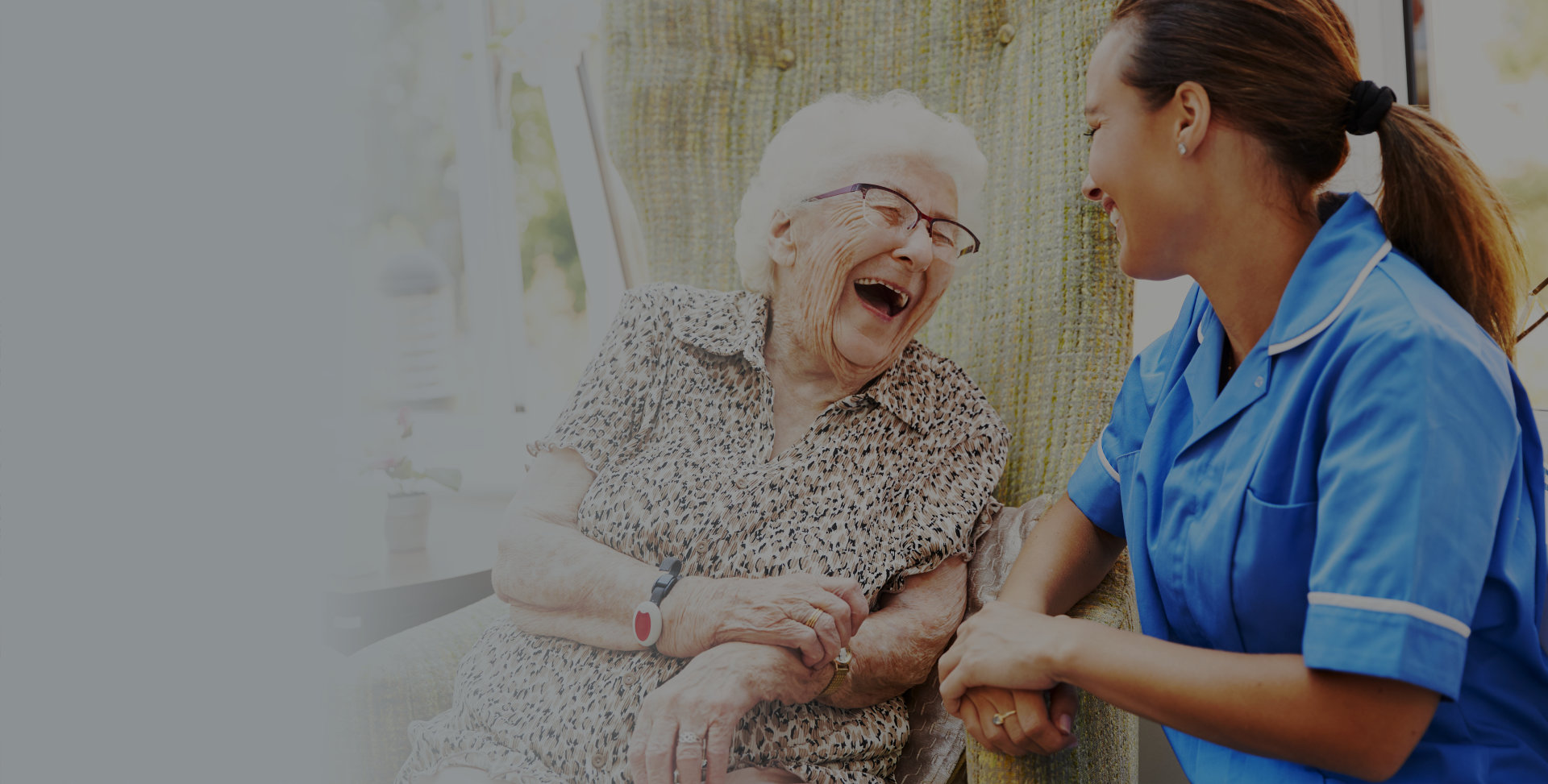 Caregiver and senior smiling at each other